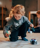 Boy plays and creates with robot