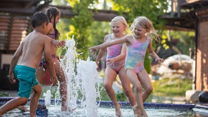 Kids splashing around in fountain