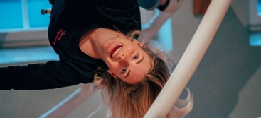 A girl is upside down i the ride space ball