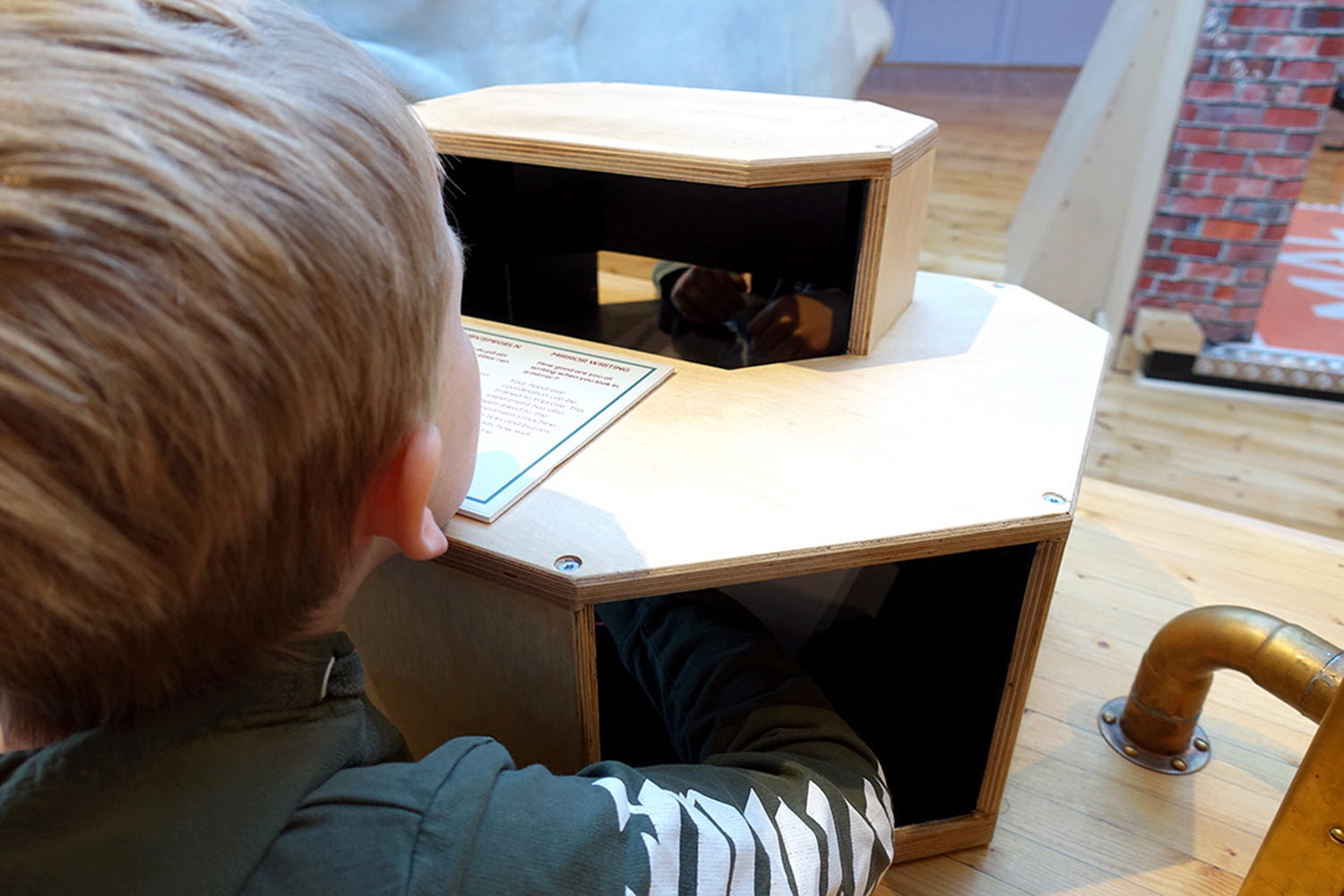 Ett barn provar experimentet Skrivspegeln Ett barn provar experimentet Skrivspegeln