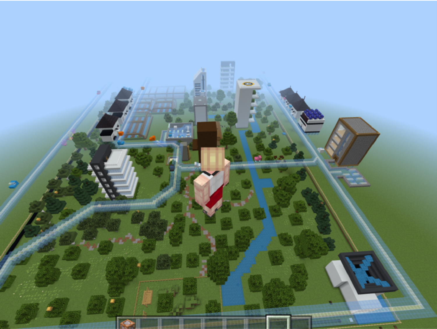Översiktsbild ifrån Minecraft med byggnader, grönska och vatten